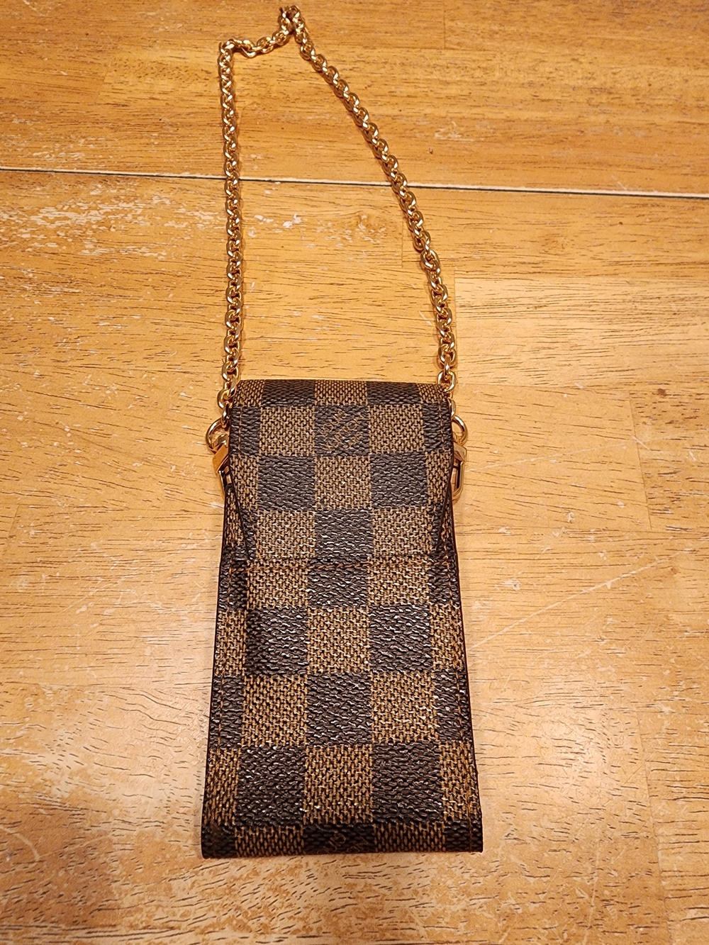 Louis Vuitton cigarette case is crafted from iconic Damier Ebene canvas